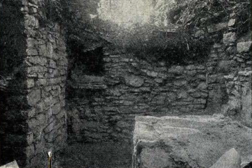 Excavated room with stone walls and windows