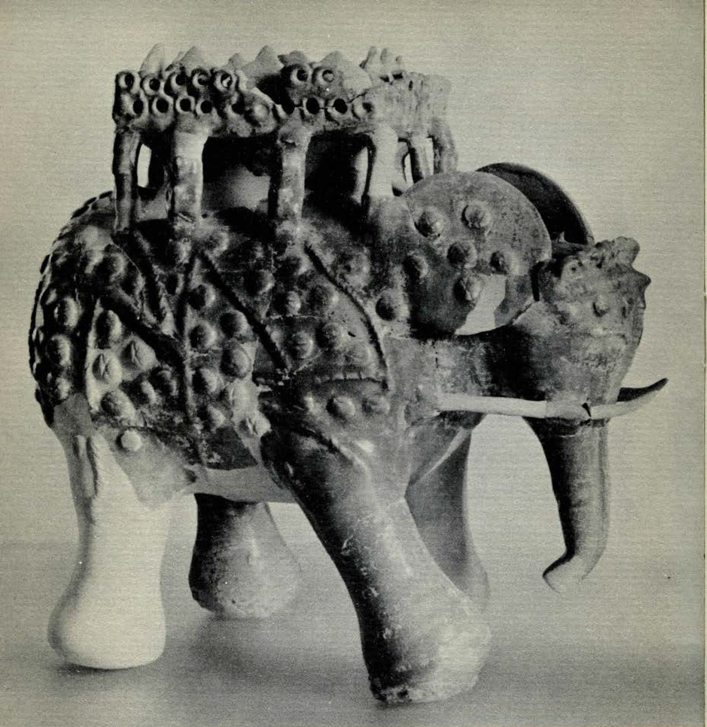 An elephant figurine with armor, a saddle, or a carriage on its back