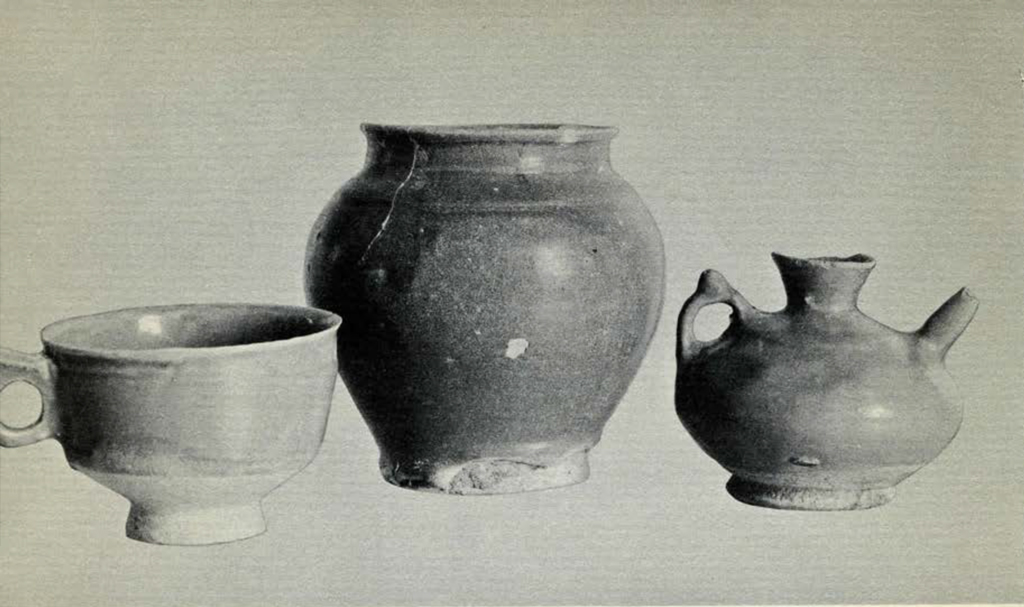 A cup with a handle, a vase or jar, and a spouted vessel with a handle