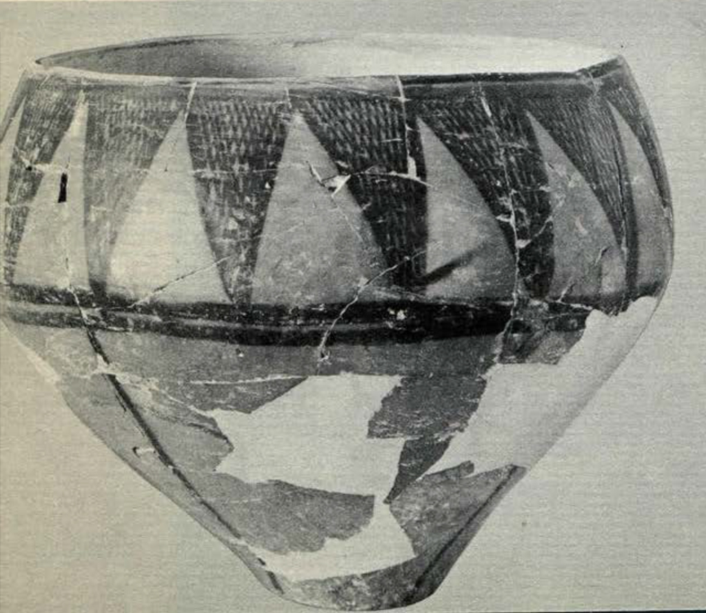 A vase or bowl with triangular pattern around the rim and top half of body