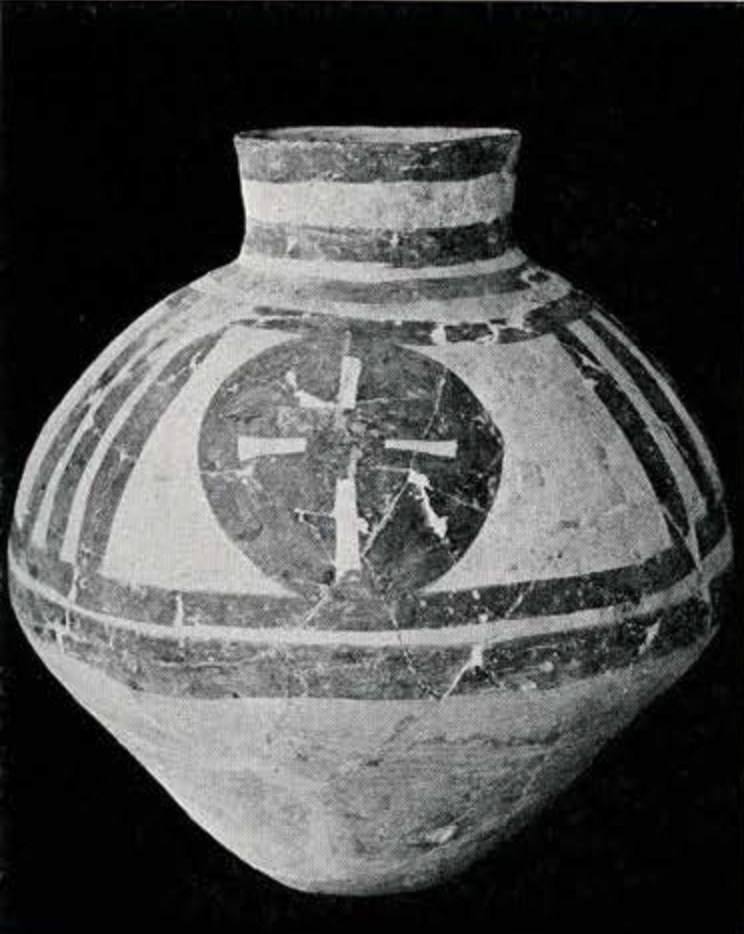 A jar, painted with geometric designs on the top half