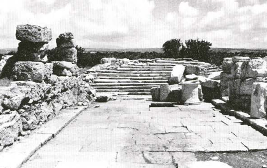 A crumbled stairway and paved area.