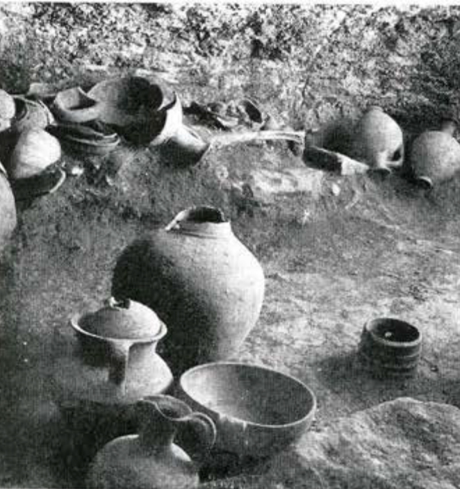 Interior of a tomb with many pots and vessels