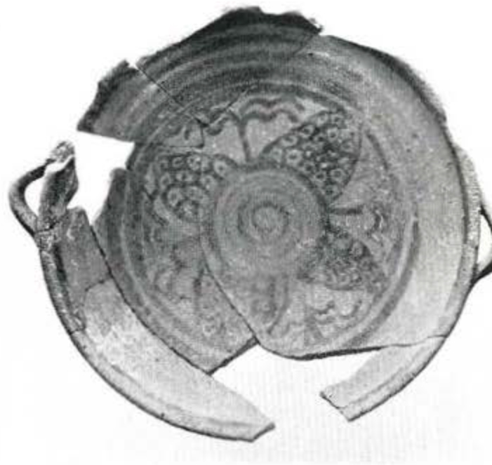 A plate with an organic design in the middle, fragments pieced together