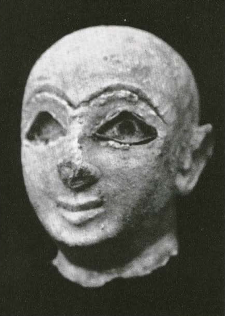 Head of a statuette with incised eyes and eyebrows, one eye inlaid with shell