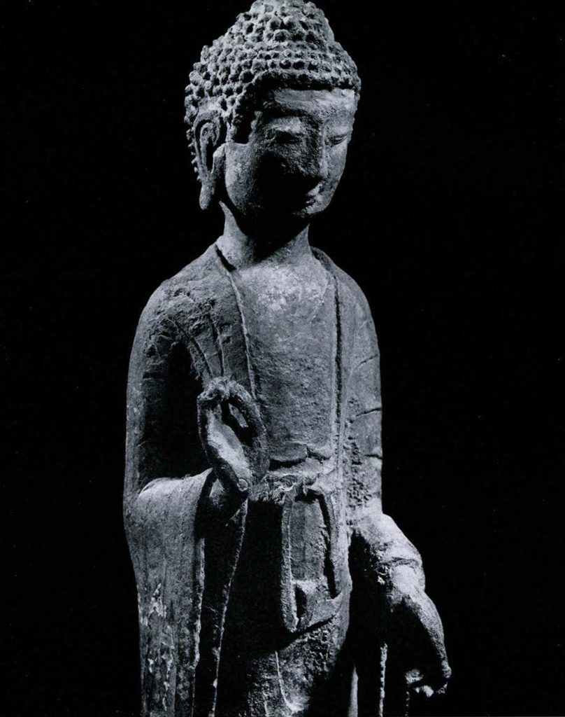 Bronze figure of Amitabha with right hand raised, palm outward, left hand low and forward, palm out, long ears, and tightly curled hair of Indian type
