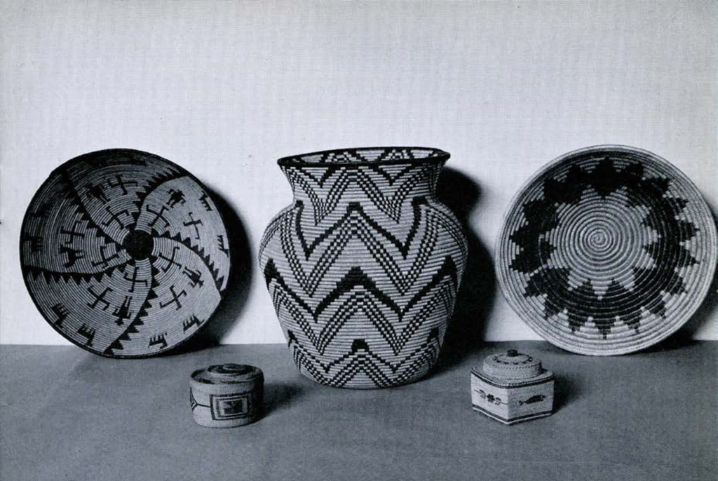 Two shallow woven baskets upright showing their interiors, a woven vase shaped basket, and two small woven trinket baskets with lids