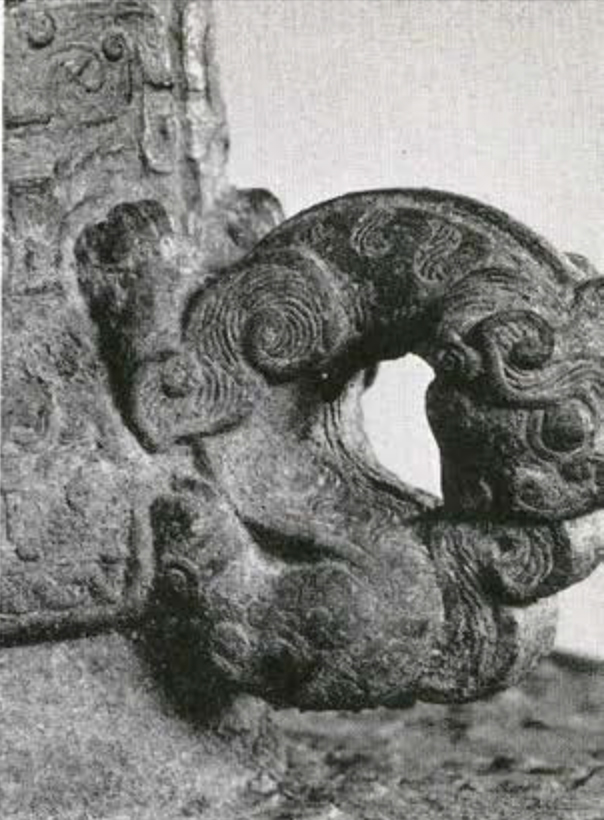 Close up of bell handle in the shape of a chimaera kitten