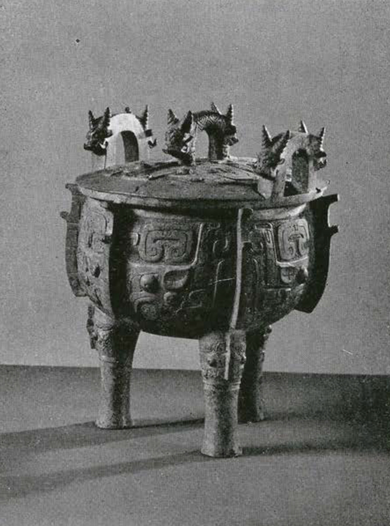 Bronze tripod vessel with three handles decorated with animals