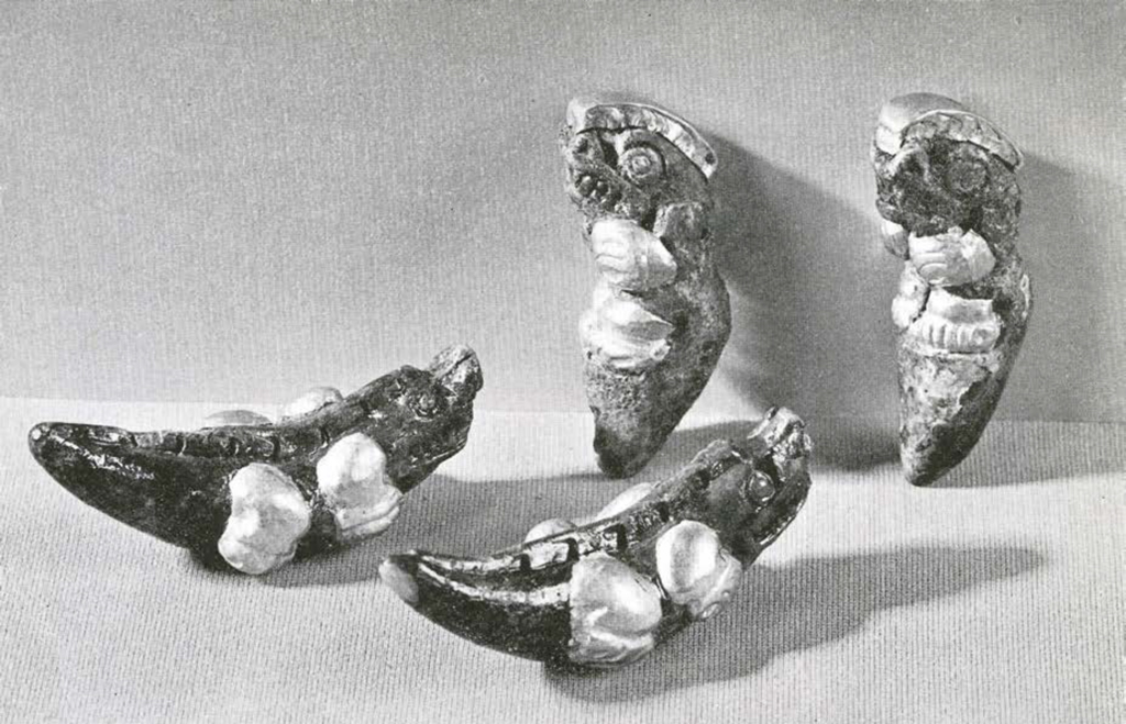 Four small whale ivory figurines in the shape of crocodiles with gold onlay on the feet and heads