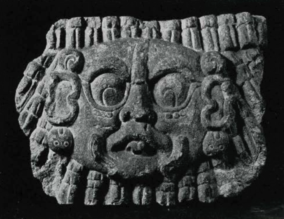 Carved stone relief of a face of the sun god