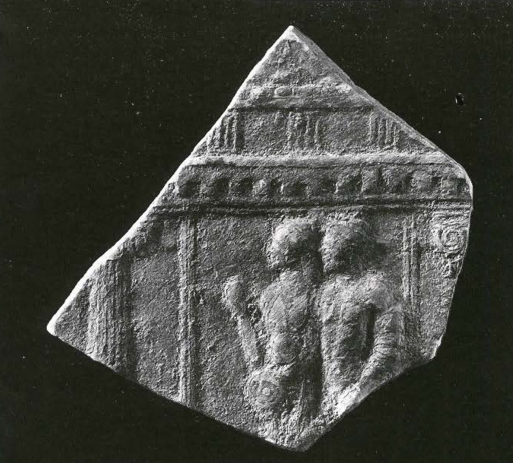 Fragment of a plaque showing two figures standing in a doorway