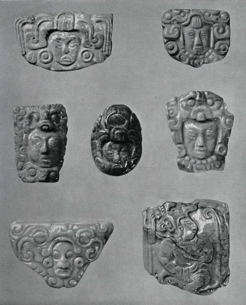 Several small jade or jadeite reliefs, mostly stylized faces, one seated figure