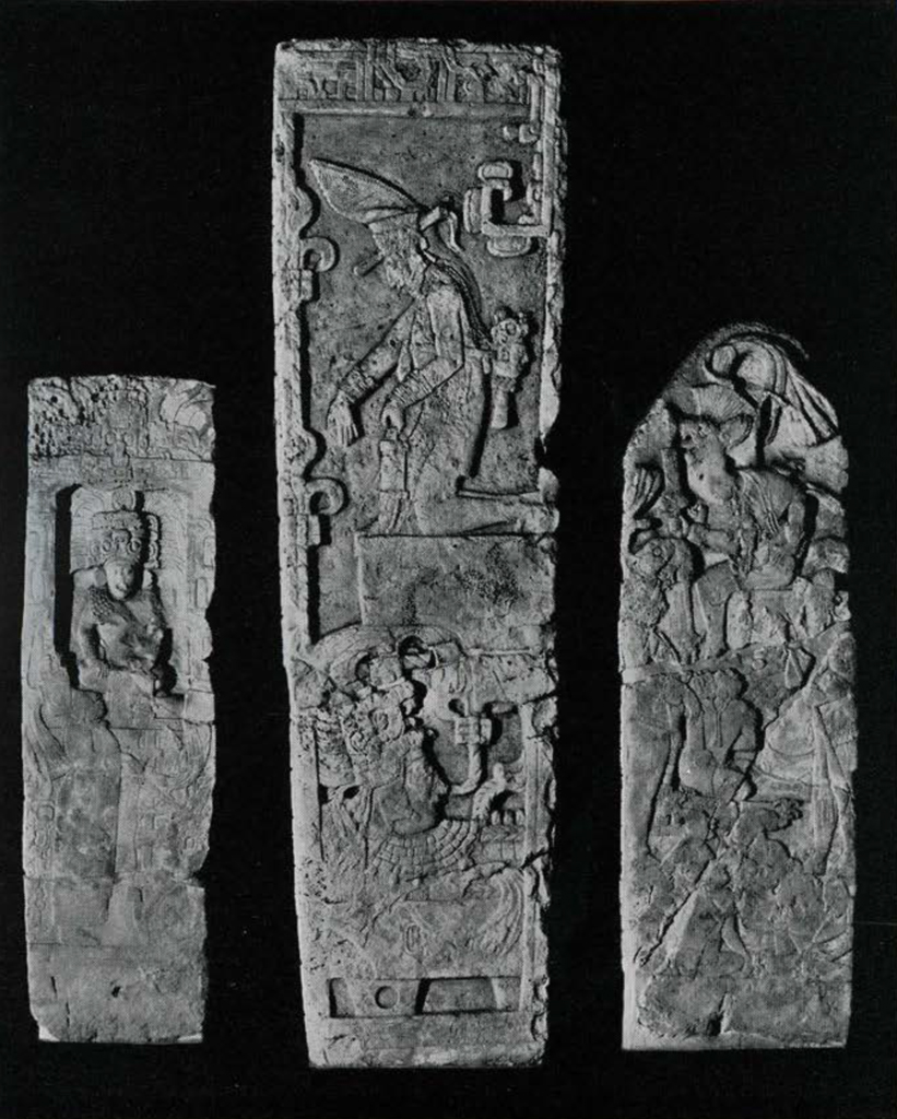 Three massive carved stone stelae depicting religious scenes and figures