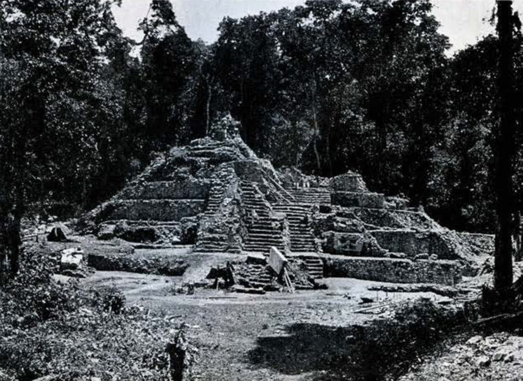 View of a stone stepped pyramid from a flat ball court