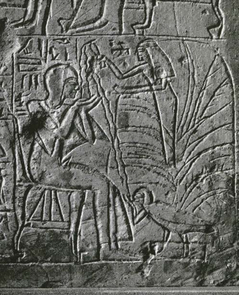 Close up of part of a scene on a funerary stela depicting a goddess pouring water on the deceased
