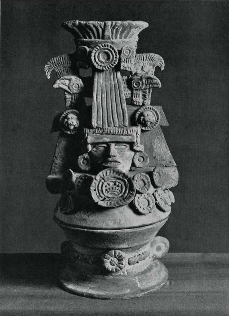 Incense burner decorated with rosettes and a human head wearing a large headdress of birds and rosettes