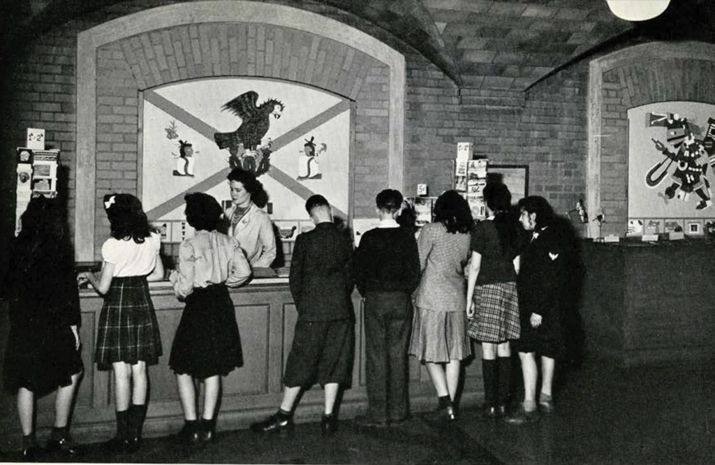 A group of school children at a counter learning in the Museum
