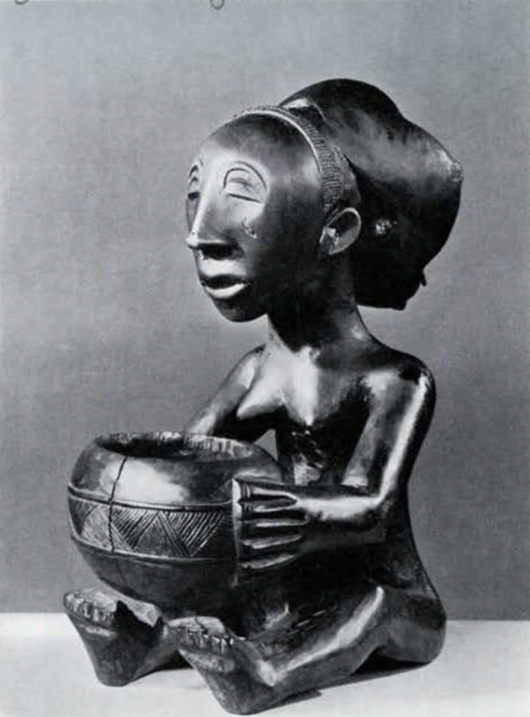 Wooden figurine of a seated woman holding a bowl