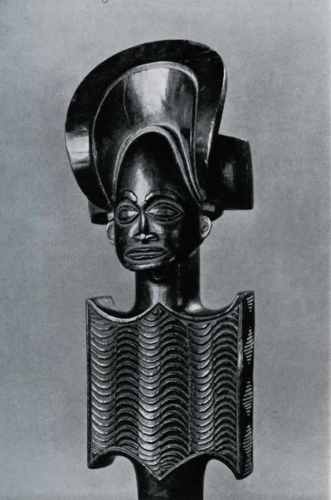 Carved wooden staff head of a figure bust with elaborate mitre-like headdress, representing a chief