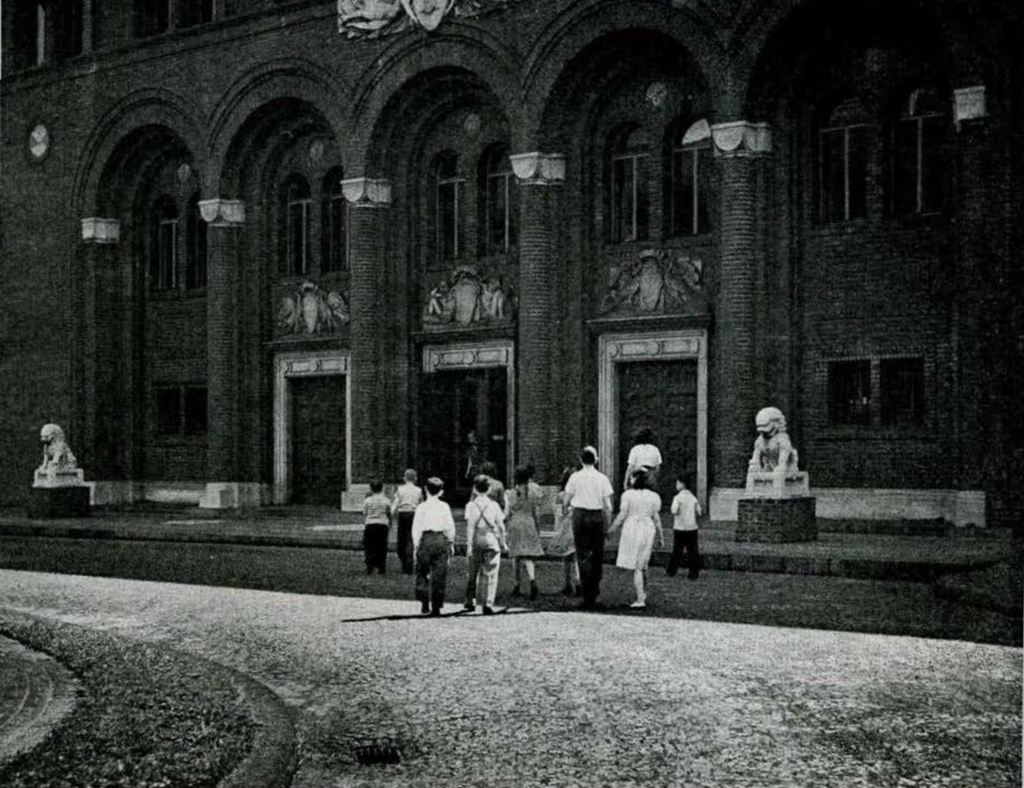 A group of school children in a paved courtyard