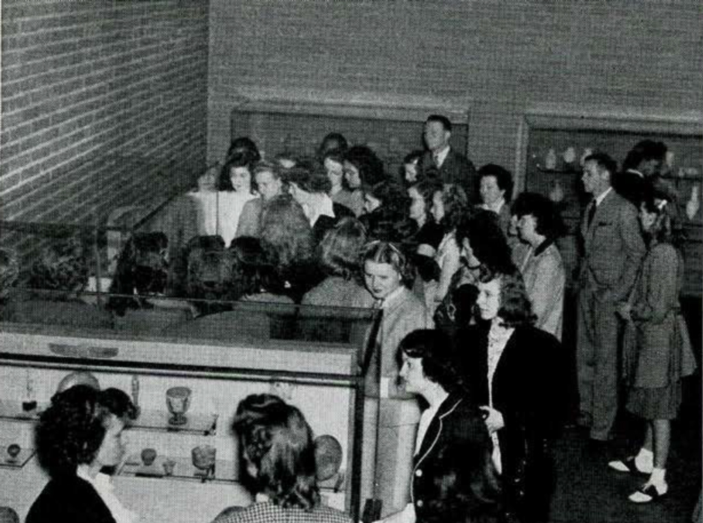 A large group of adults crowded around a display in the Egypt gallery
