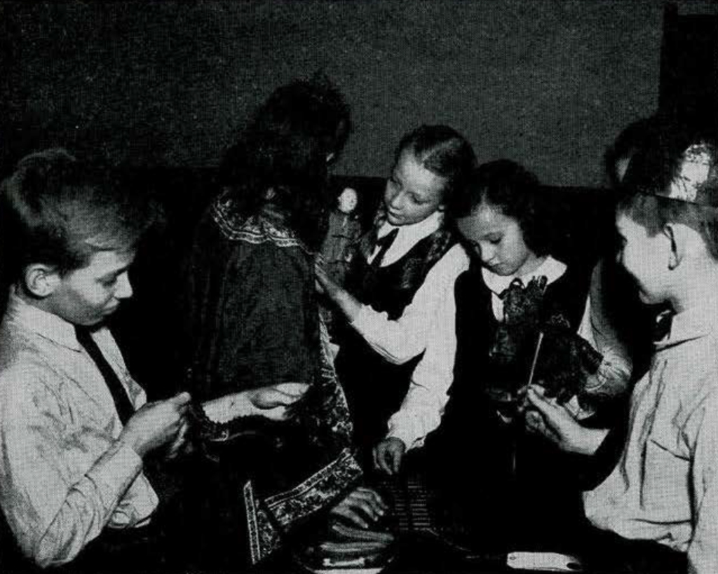 A group of children holding and inspecting objects