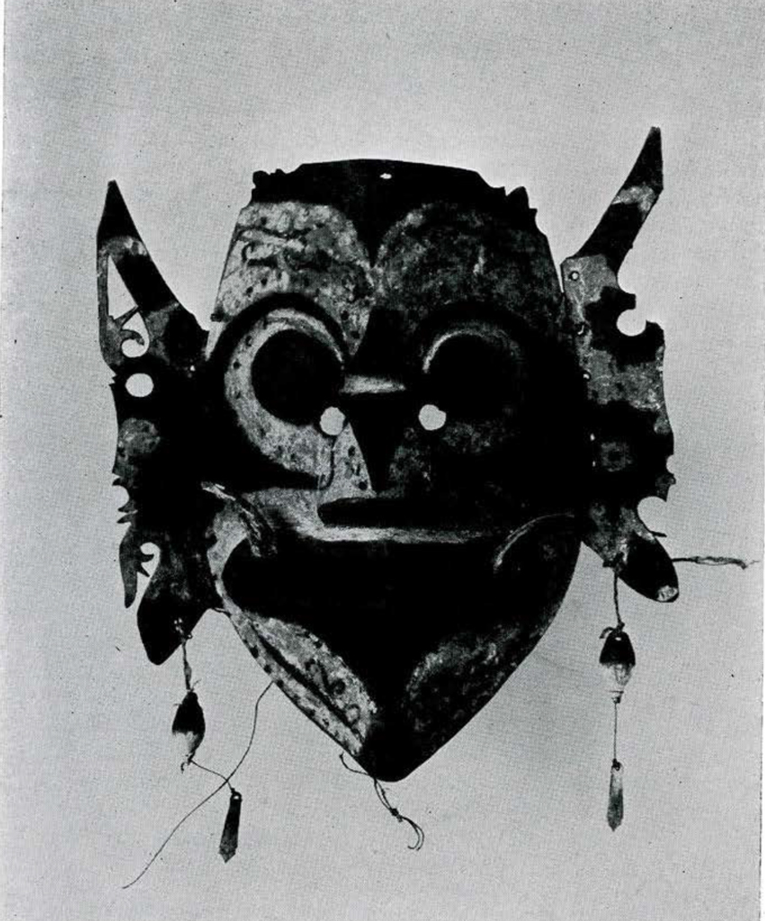 An intricate mask with large ear like protrusions and a stylized face.