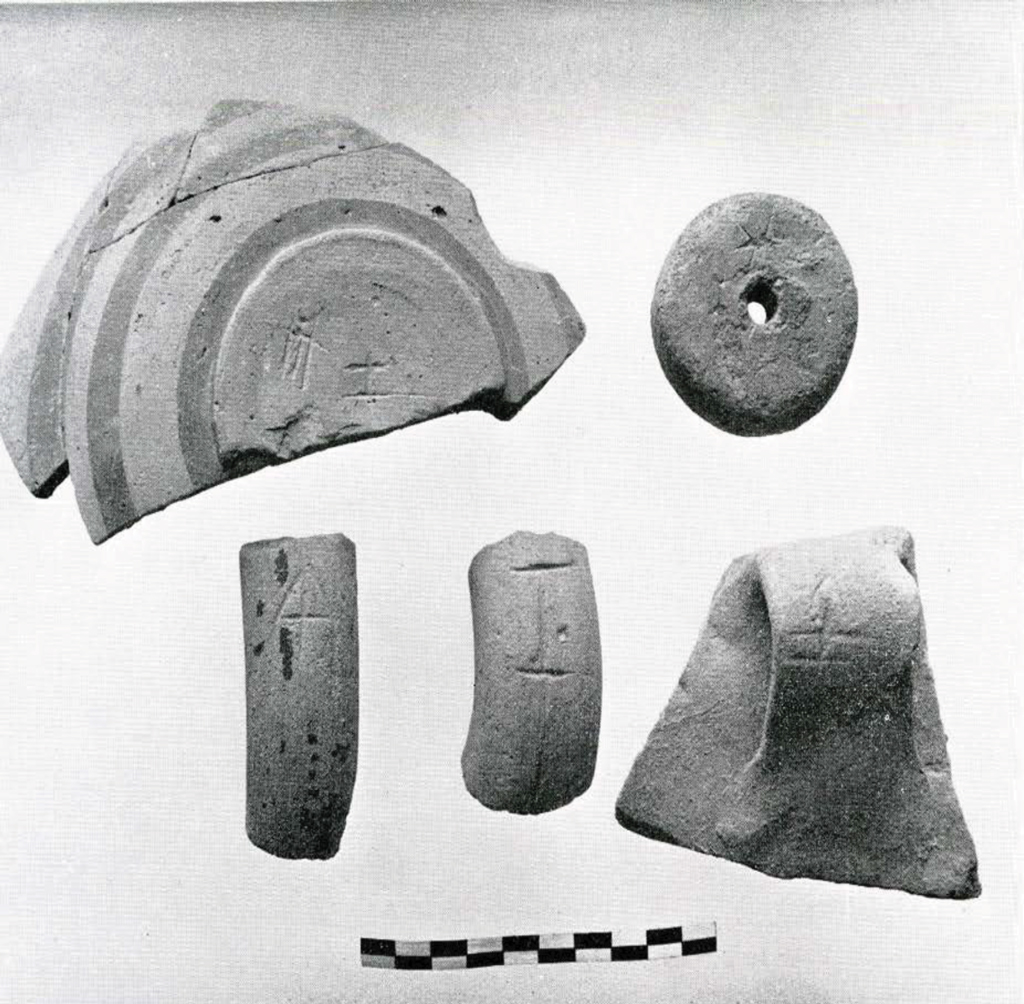 An assortment of sherds with partial inscriptions.