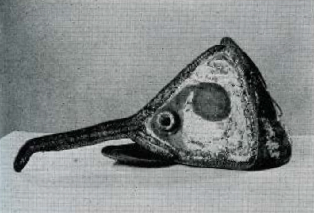 A rattan mask in the shape of a fish head with long protrusion.