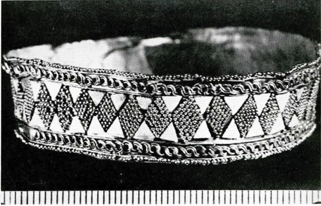A gold bracelet with beaded diamond pattern in the middle register.