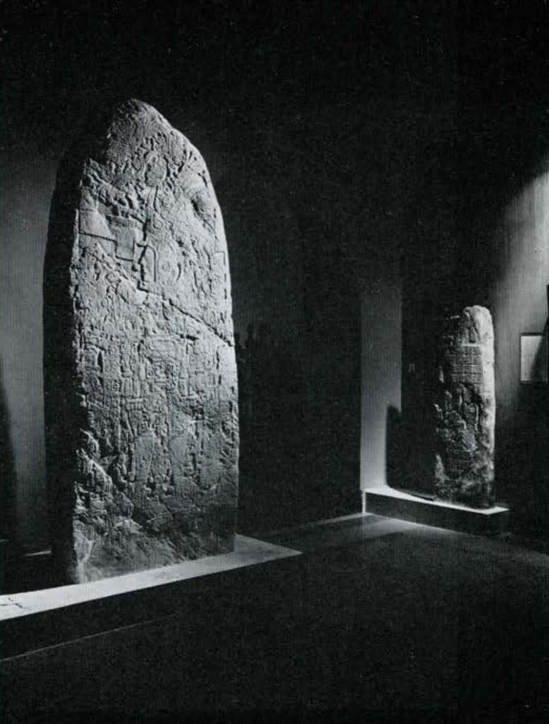 Two stela standing and lit from below in the Museum.