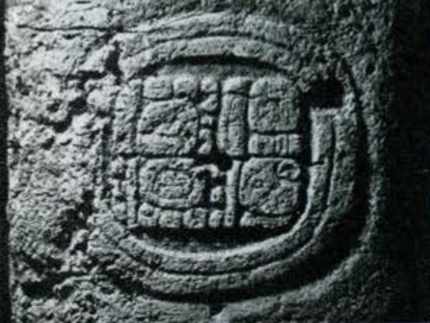 Close up of a carved glyph in a carved circle at the base of Stela 19.