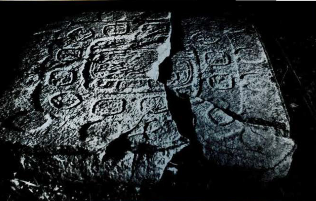 Large stone altar, cracked down the middle, covered in glyphs.