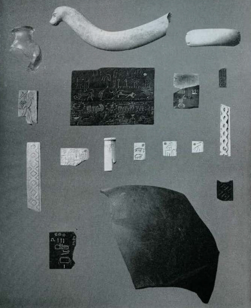 An assortment of objects, many inscribed or inlaid.