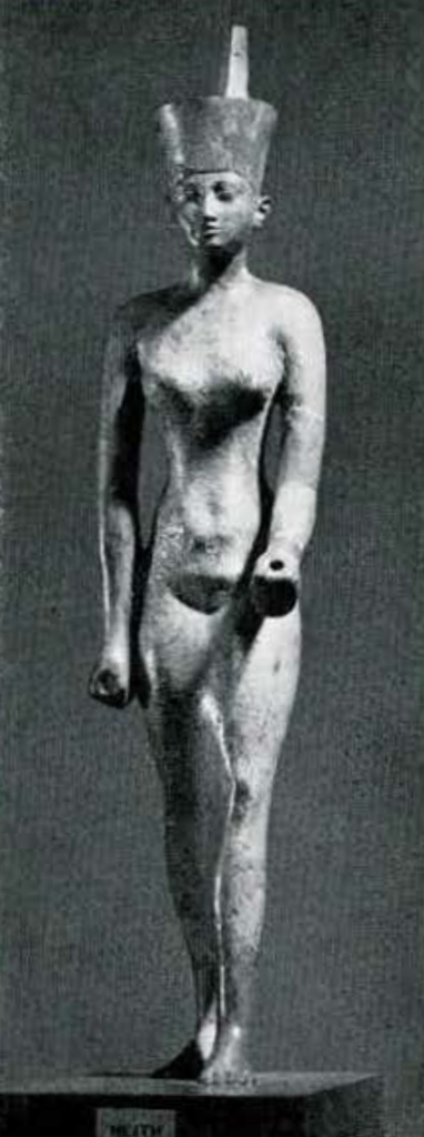 Standing bronze statuette of Neith wearing a long, tight-fitting dress and the crown of Lower Egypt.
