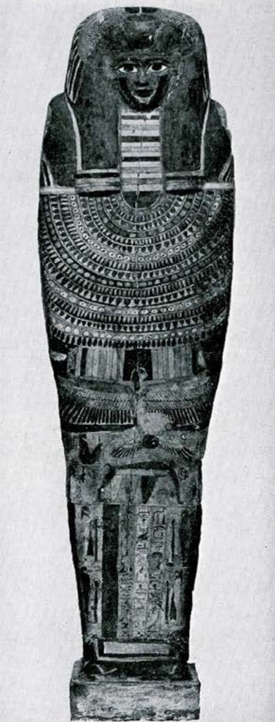 A coffin lid with a persons face and intricated designs on the body.