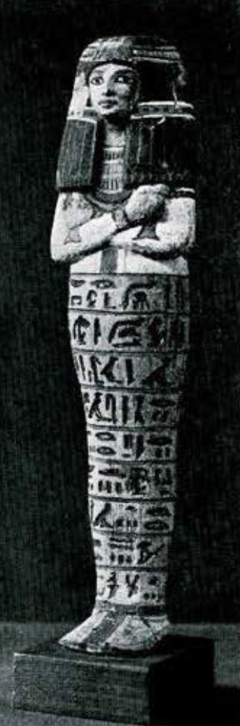 Painted wooden shabti with arms crossed, wearing a long wig and collar.