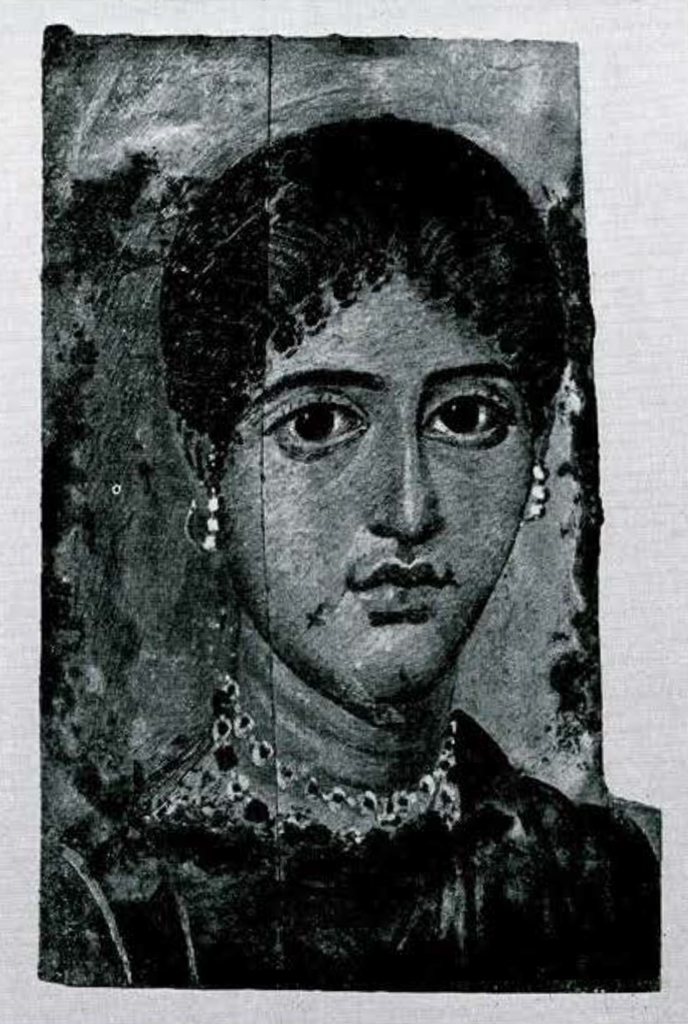 Encaustic portrait on wood of a full featured, elegantly dressed and bejeweled matron, wearing a hairstyle of second century AD.