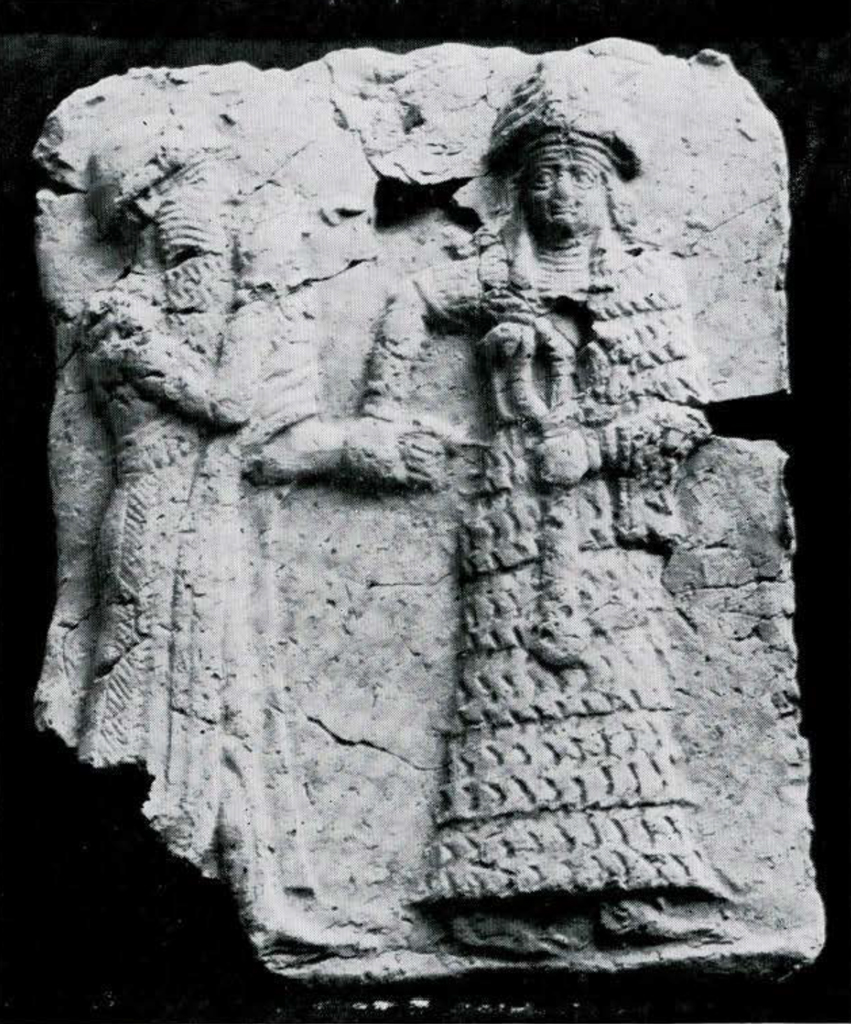 A plaque with a goddess leading a man by the hand in relief.