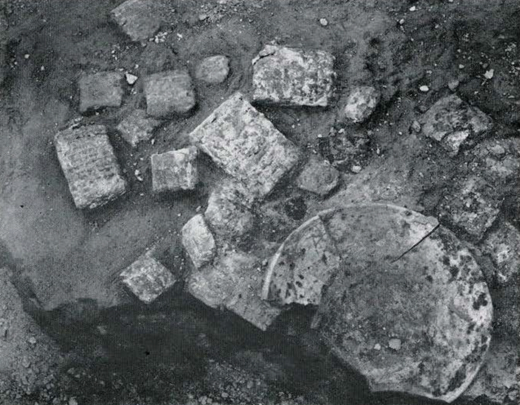 Many tablets laying in the dirt.