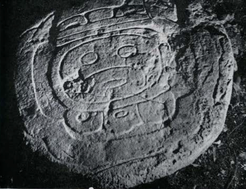 A rounded altar with a date glyph carved into it.
