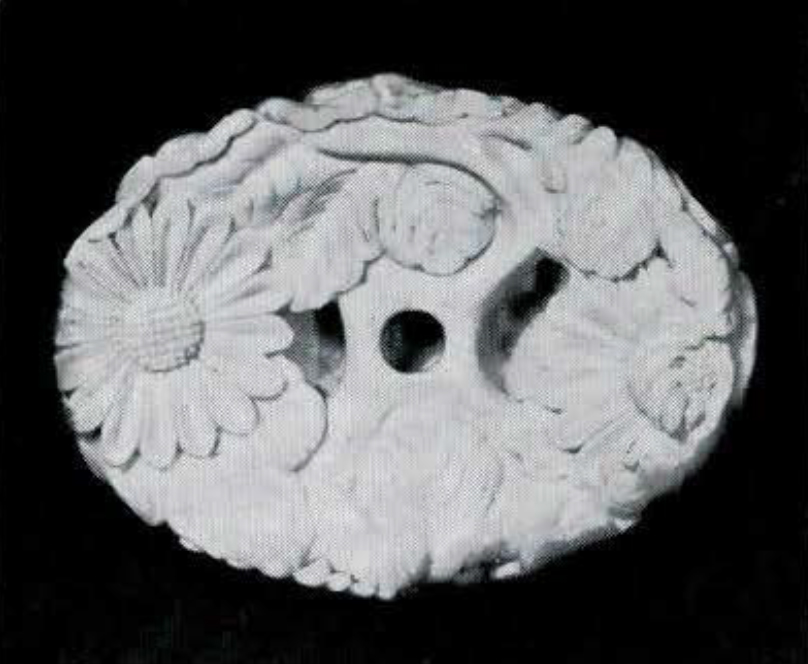 Reverse of a piece of hornbill carved with a floral design.
