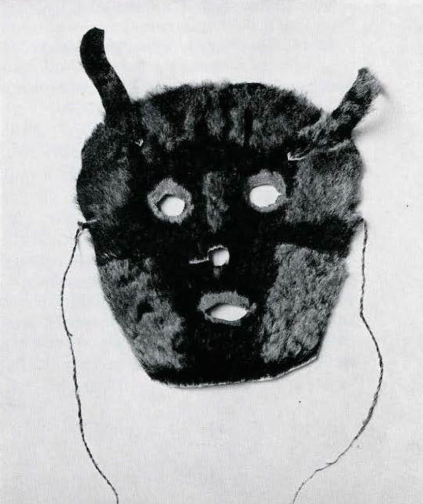Mask made of skin with fur still attached, some shearing to form patterns, ears of the same skin sewn on.