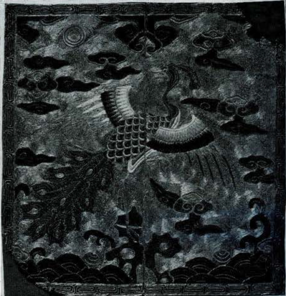 Civil official rank badge, third rank, at  the center a peacock, looking backwards towards the sun, stands with wings spread on a rock among waves with two pearls.