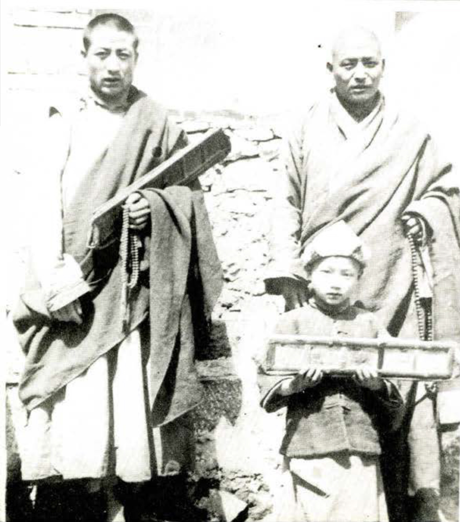 Two men standing with a child.