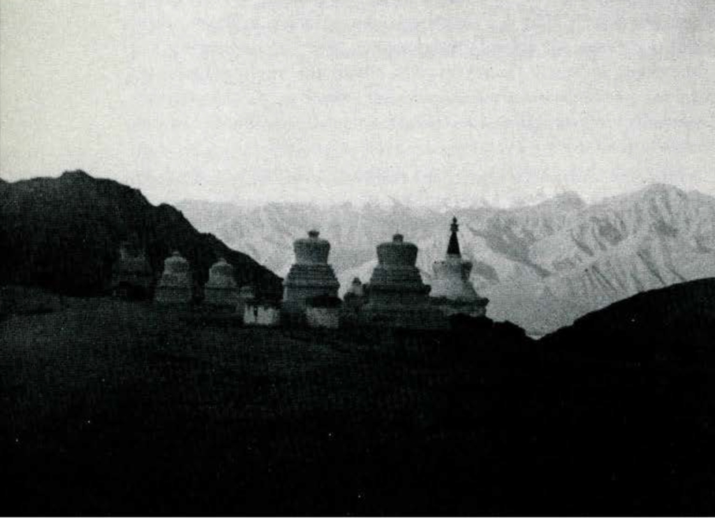 A line of stupas in the midst of the mountains.