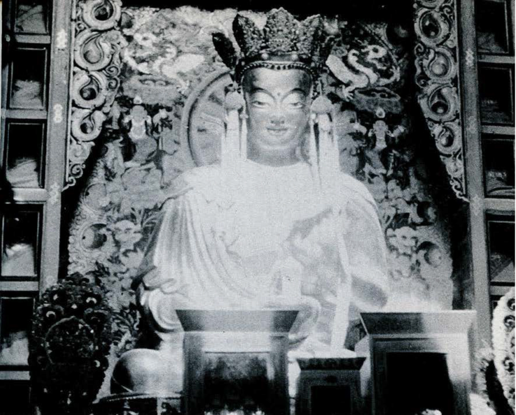 A giant golden image of the Buddha wearing a crown.