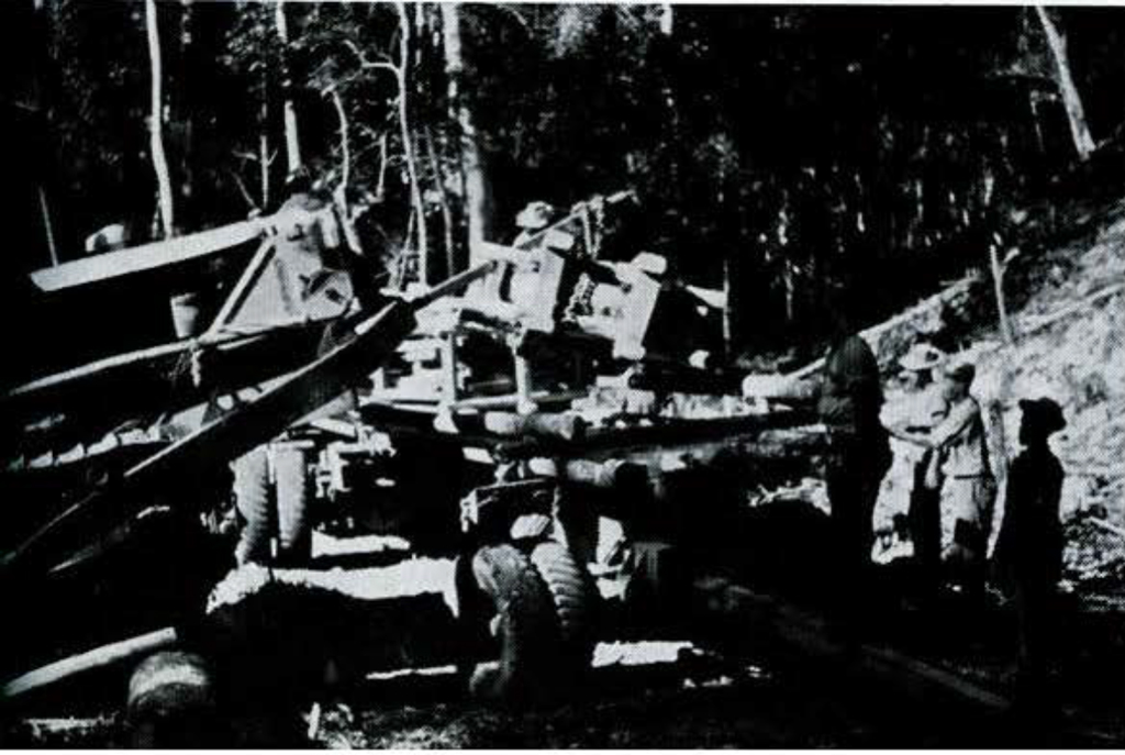 A group of men loading a massive wooden crate onto a truck bed.