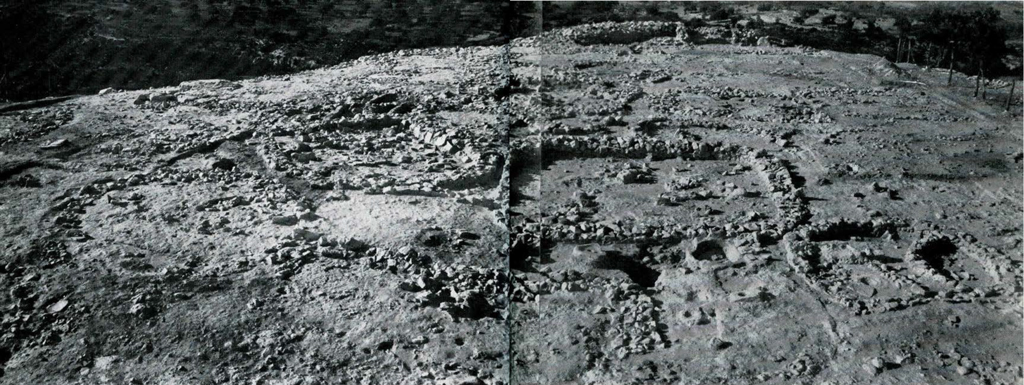 View of a large excavated area, with rocks outlining where buildings used to be.
